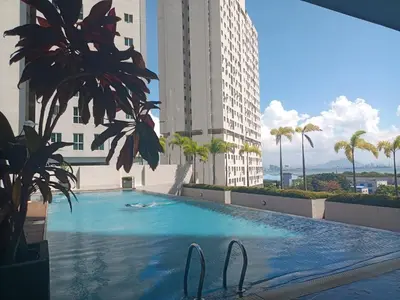a large swimming pool in the middle of a building at Deluxe suites 3, 1BR, 2-5 pax, Netflix, Georgetown in George Town