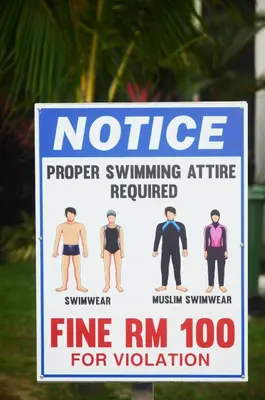 a sign that says notice proper swimming attire required at Groundfloor Poolside Manhattan Ipoh Free Netflix&Carpark in Ipoh