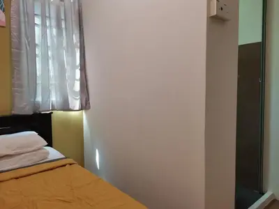 a bedroom with a bed and a window at G FORTUNE HOTEL + in George Town