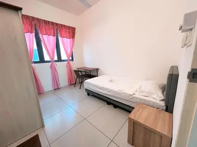 a bedroom with a bed and a window with pink curtains at SZ Home Legacy at Meritus in Perai