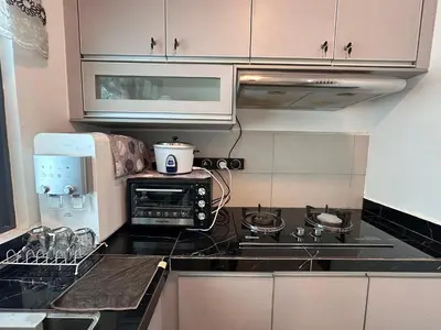 a kitchen with a stove and a microwave at SZ Home Legacy at Meritus in Perai