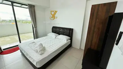 a bedroom with a bed with white sheets and towels at SZ Home Legacy at Meritus in Perai