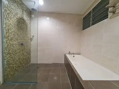 a bathroom with a tub and a glass shower at D'Sea Marina Island Resort by Manhattan Group in Lumut