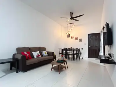 a living room with a couch and a table at Samudera Seri Manjung Residences by Manhattan Group in Kampong Pundut