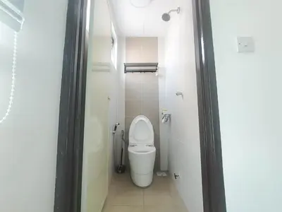 a small bathroom with a toilet in a stall at Samudera Seri Manjung Residences by Manhattan Group in Kampong Pundut