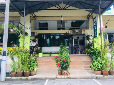 a building with a bunch of plants on the stairs at Lily Haven Hotel C-1 in Tanah Rata