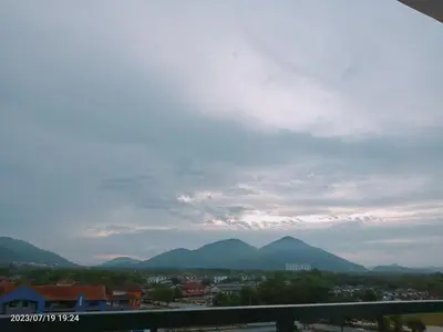 a view of a city and mountains under a cloudy sky at Homestay Triple Q Manjung in Seri Manjung