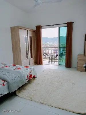 a bedroom with a bed and a view of a balcony at Homestay Triple Q Manjung in Seri Manjung