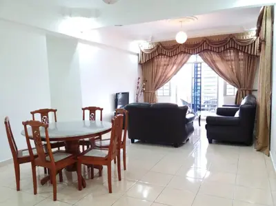 a living room with a table and chairs and a couch at Emerald New Homstay in Brinchang