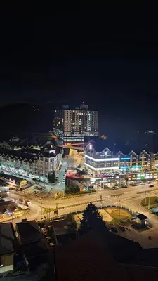 a city lit up at night with buildings and street lights at Emerald New Homstay in Brinchang