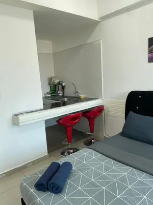 a room with a counter and a sink and a bed at GR studio APARTMENT 1 - kompleks MUTIARA gua MUSANG in Gua Musang