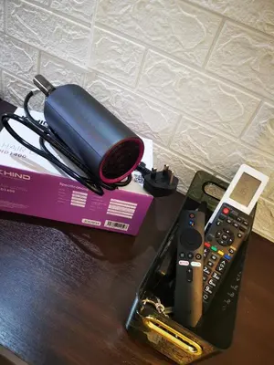 a remote control and a cell phone on a table at Minimaliste Ipoh Garden 2 minute to stadium 5BR5BR in Ipoh