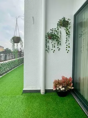 a white wall with two potted plants on a balcony at The Horizon @ Ipoh - Cozy Condo with Balcony Patio in Ipoh