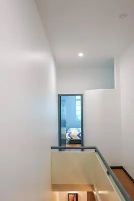 a stair case in a white building with a stair railing at MODERN HERITAGE HOUSE``````Georgetown\u4e54\u6cbb\u5e02 in George Town