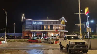 a truck parked in front of a mcdonalds building at night at Brinchang Cameron Highlands Homstay in Brinchang