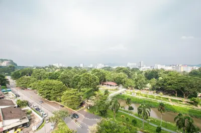 an aerial view of a city with a street and trees at Cosy City-View Suite in Town in Ipoh
