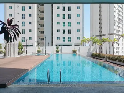 a large swimming pool with buildings in the background at Deluxe Suites 4, 2-5 pax, Netflix, Georgetown in Jelutong