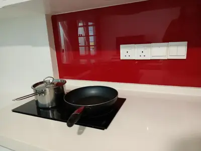 a pots and pans on a stove in a kitchen at Deluxe Suites 4, 2-5 pax, Netflix, Georgetown in Jelutong