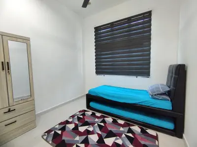 a room with a bed and a window and a rug at Indah Damai Homestay in Kepala Batas
