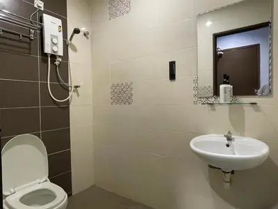 a bathroom with a toilet and a sink at M Three Hotel in Kampong Batu Tiga