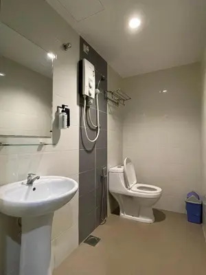 a bathroom with a sink and a toilet and a phone at M Three Hotel in Kampong Batu Tiga