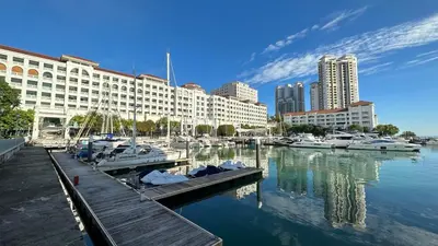 a marina with boats in the water next to buildings at Straits Quay Highest & Spacious Seaview Suite - 2 in Tanjong Tokong