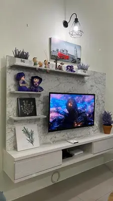 a living room with a tv on a stone wall at Sweet Homestay 3RM @ Penthouse Apartment in Brinchang in Brinchang