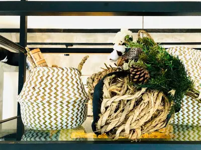 a shelf with two wicker baskets and pine cones at INS White House Ipoh in Ipoh