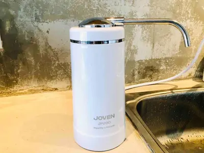 a white cup sitting on a counter next to a sink at INS White House Ipoh in Ipoh