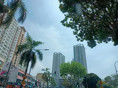 a city street with palm trees and tall buildings at Deluxe Suites 5, 2-4 pax , Netflix, Georgetown in Jelutong