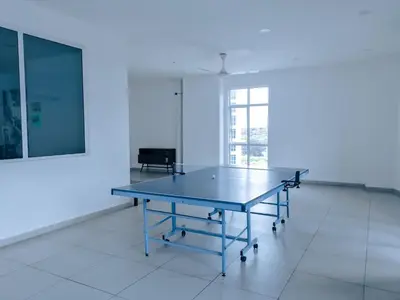 a ping pong table in the middle of a room at Strait Garden Family Suites by Maj in Jelutong