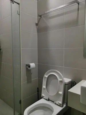 a bathroom with a toilet with the lid up at Strait Garden Family Suites by Maj in Jelutong