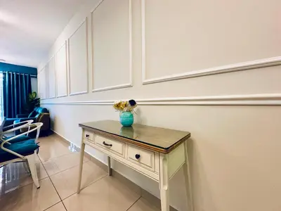 a room with a table with a vase on it at The Majestic Ipoh Town - Mountain View in Ipoh