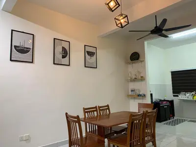 a dining room with a wooden table and chairs at Juwita&Arjuna Homestay Teluk Senangin in Kampong Batu Tiga