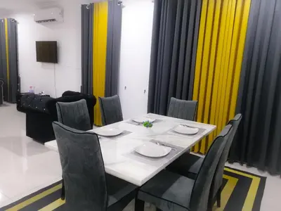 a dining room with a white table and chairs at Marvelous Homestay SP Kedah in Sungai Petani
