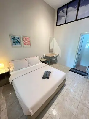 a bedroom with a large white bed and a table at myRoom Georgetown, Off Jalan Burma, Gurney Drive in George Town