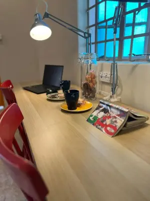 a table with a laptop and a plate of food on it at myRoom Georgetown, Off Jalan Burma, Gurney Drive in George Town