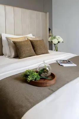 a white bed with a bowl of plants on it at Georgetown Luxury Heritage House 4BR 10Pax in George Town