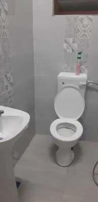 a bathroom with a white toilet and a sink at Ain's Homestay Muslim friendly Kuala Kubu Bharu in Kuala Kubu Baharu