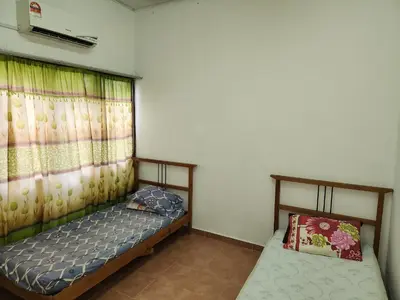 a small bedroom with a bed and a window at Reyza Homestay KKB in Kuala Kubu Baharu
