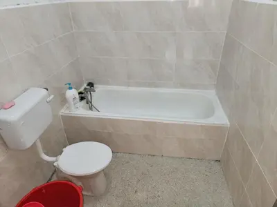 a bathroom with a toilet and a bath tub at Reyza Homestay KKB in Kuala Kubu Baharu