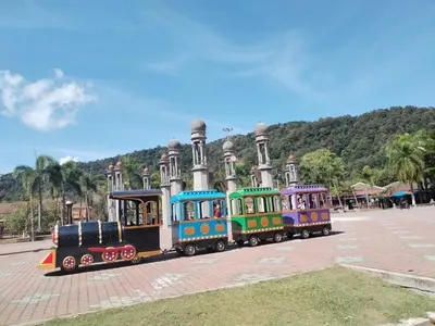 a small train in front of a building at Teluk Batik Holiday Apartment in Lumut