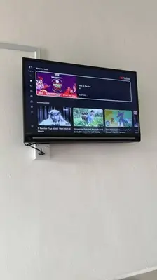 a flat screen tv hanging on a wall at Ipoh stadium 1min/wahkeongpark simee 18pax bungalow cottage in Ipoh