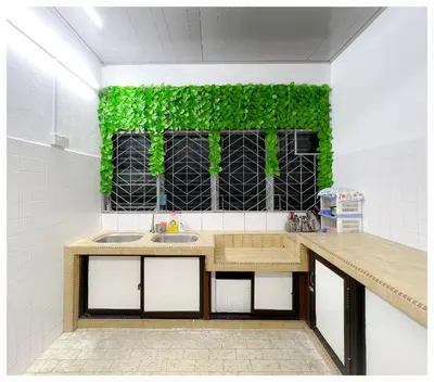 a kitchen with a sink and a green wall at ✩ 23 HOUSE ✩ 23号 复古老宅 ✩ Vintage Homestay in Butterworth