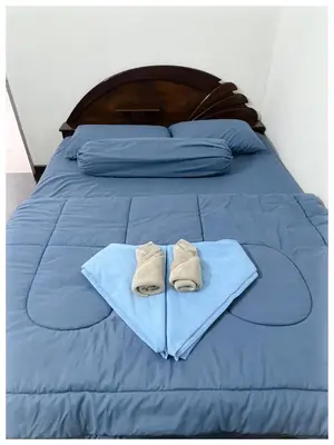 a bed with blue sheets and two towels on it at ✩ 23 HOUSE ✩ 23号 复古老宅 ✩ Vintage Homestay in Butterworth