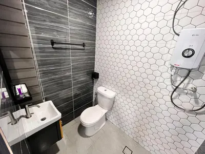 a bathroom with a toilet and a sink at BEATRIX HOTEL in Brinchang