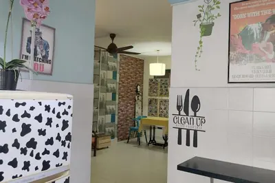 a dining room with a table and a ceiling fan at Comfy Home Near to Penang Hill in Ayer Itam