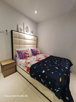 a bedroom with a bed with a comforter on it at Aiera Homestay @ Meru Casa Kayangan in Ipoh