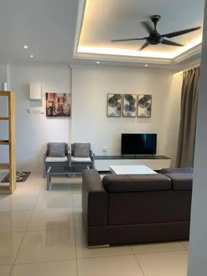 a living room with a couch and a ceiling fan at Aiera Homestay @ Meru Casa Kayangan in Ipoh