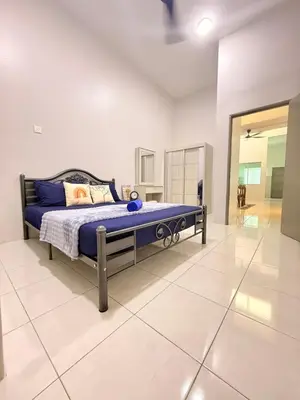 a bedroom with a bed with blue sheets on it at QM_Homestay Bagan Serai in Bagan Serai